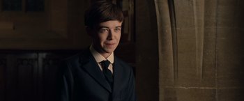 Movie still from “The Imitation Game” (2014), directed by Morten Tyldum – A man in a suit and tie in a dark room; Close Up shot, Over the shoulder angle