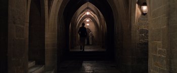 Movie still from “The Imitation Game” (2014), directed by Morten Tyldum – A man walking down a hallway in an archway; Extreme Wide shot, Low angle