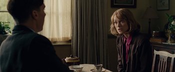 Movie still from “The Imitation Game” (2014), directed by Morten Tyldum – A woman sitting at a table with a tea pot in front of a window; Medium shot, Over the shoulder angle