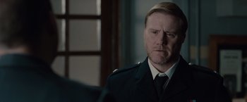 Movie still from “The Imitation Game” (2014), directed by Morten Tyldum – A person wearing a suit and tie; Close Up shot, Over the shoulder angle