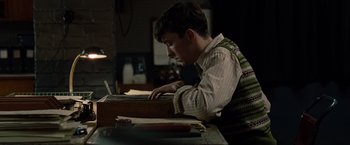 Movie still from “The Imitation Game” (2014), directed by Morten Tyldum – A young man is typing on a laptop computer; Medium shot, Low angle
