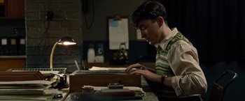 Movie still from “The Imitation Game” (2014), directed by Morten Tyldum – A young man is typing on an old fashioned typewriter; Medium shot, High angle