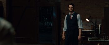 Movie still from “The Imitation Game” (2014), directed by Morten Tyldum – A man standing in front of a brick building; Medium shot, Over the shoulder angle