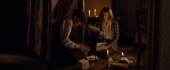 Movie still from “The Imitation Game” (2014), directed by Morten Tyldum – A man and a woman sitting on the floor with papers; Medium shot, High angle