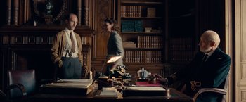 Movie still from “The Imitation Game” (2014), directed by Morten Tyldum – A man and a woman standing in front of a desk; Medium shot, Over the shoulder angle
