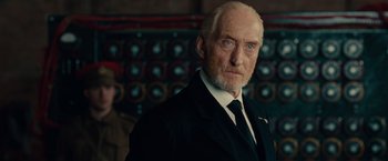 Movie still from “The Imitation Game” (2014), directed by Morten Tyldum – An older man wearing a suit and tie; Close Up shot, Low angle