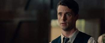 Movie still from “The Imitation Game” (2014), directed by Morten Tyldum – A person wearing a suit and tie; Close Up shot, Over the shoulder angle