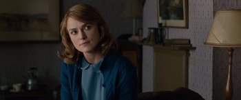 Movie still from “The Imitation Game” (2014), directed by Morten Tyldum – A woman sitting in front of a couch in a room; Close Up shot, Over the shoulder angle