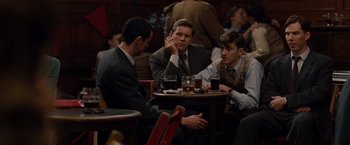 Movie still from “The Imitation Game” (2014), directed by Morten Tyldum – A group of men sitting at a table drinking beer; Medium shot, Over the shoulder angle