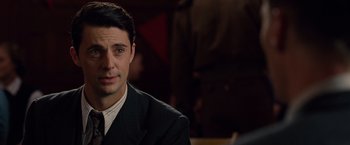 Movie still from “The Imitation Game” (2014), directed by Morten Tyldum – A man in a suit and tie; Close Up shot, Over the shoulder angle