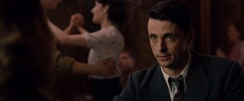 Movie still from “The Imitation Game” (2014), directed by Morten Tyldum – A man sitting in front of a woman in front of a camera; Close Up shot, Over the shoulder angle