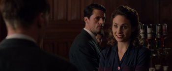 Movie still from “The Imitation Game” (2014), directed by Morten Tyldum – A man and a woman standing next to each other in a courtroom; Close Up shot, Over the shoulder angle