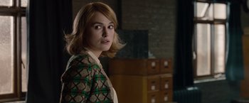 Movie still from “The Imitation Game” (2014), directed by Morten Tyldum – A woman in a green and white jacket standing in a room; Close Up shot, Over the shoulder angle