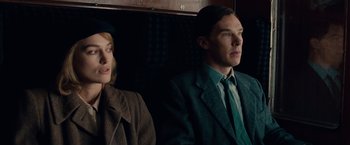 Movie still from “The Imitation Game” (2014), directed by Morten Tyldum – A man and a woman sitting next to each other on a train; Close Up shot, Over the shoulder angle