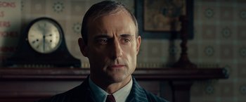 Movie still from “The Imitation Game” (2014), directed by Morten Tyldum – A person wearing a suit and tie; Close Up shot, Low angle