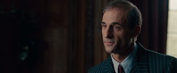 Movie still from “The Imitation Game” (2014), directed by Morten Tyldum – A person wearing a suit and tie; Close Up shot, Over the shoulder angle