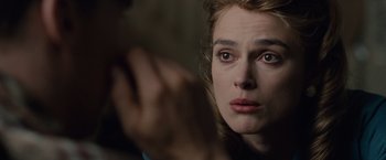 Movie still from “The Imitation Game” (2014), directed by Morten Tyldum – A woman's face in a dark room; Close Up shot, Over the shoulder angle