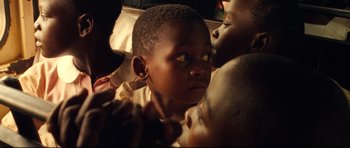 Movie still from “The Last King of Scotland” (2006), directed by Kevin Macdonald – A young child with a baby; Close Up shot, High angle