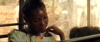 Movie still from “The Last King of Scotland” (2006), directed by Kevin Macdonald – A woman sitting in front of a window looking out; Close Up shot, Over the shoulder angle