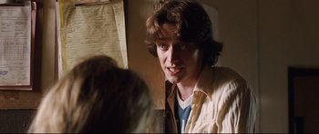 Movie still from “The Last King of Scotland” (2006), directed by Kevin Macdonald – A young man is looking at the camera; Close Up shot, Over the shoulder angle