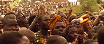 Movie still from “The Last King of Scotland” (2006), directed by Kevin Macdonald – A group of people gathered together in a field; Close Up shot, High angle