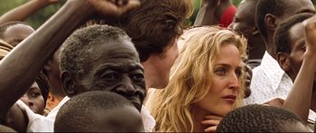 Movie still from “The Last King of Scotland” (2006), directed by Kevin Macdonald – A man and a woman standing next to each other in a crowd; Close Up shot, Over the shoulder angle