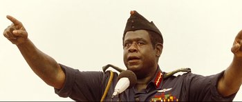 Movie still from “The Last King of Scotland” (2006), directed by Kevin Macdonald – A man in a military uniform speaking into a microphone; Close Up shot, Low angle
