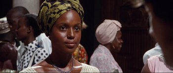 Movie still from “The Last King of Scotland” (2006), directed by Kevin Macdonald – A person wearing a head scarf; Close Up shot, Over the shoulder angle