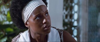 Movie still from “The Last King of Scotland” (2006), directed by Kevin Macdonald – A person wearing a head band; Close Up shot, Over the shoulder angle