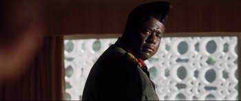 Movie still from “The Last King of Scotland” (2006), directed by Kevin Macdonald – A man in a military uniform is standing in front of a window; Close Up shot, Low angle