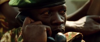 Movie still from “The Last King of Scotland” (2006), directed by Kevin Macdonald – A person with his hand under his chin; Close Up shot, Low angle