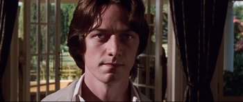 Movie still from “The Last King of Scotland” (2006), directed by Kevin Macdonald – A person with long brown hair; Close Up shot, Low angle