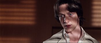Movie still from “The Last King of Scotland” (2006), directed by Kevin Macdonald – A young man in a white shirt and a jacket; Close Up shot, Low angle