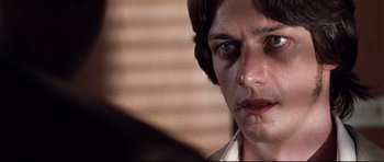 Movie still from “The Last King of Scotland” (2006), directed by Kevin Macdonald – A person with a blue eye; Close Up shot, Over the shoulder angle