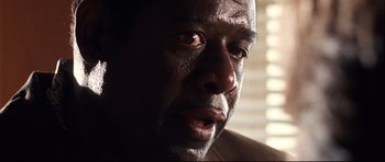 Movie still from “The Last King of Scotland” (2006), directed by Kevin Macdonald – A man's face in the sunlight; Close Up shot, Low angle