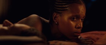 Movie still from “The Last King of Scotland” (2006), directed by Kevin Macdonald – A person laying on the ground; Close Up shot, High angle