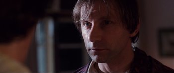 Movie still from “The Last King of Scotland” (2006), directed by Kevin Macdonald – A man's face in a dark room; Close Up shot, Low angle