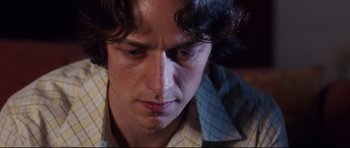 Movie still from “The Last King of Scotland” (2006), directed by Kevin Macdonald – A person looking down at his face; Close Up shot, Low angle