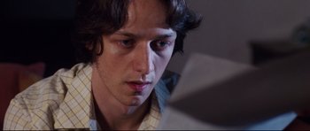 Movie still from “The Last King of Scotland” (2006), directed by Kevin Macdonald – A man looking at a computer screen; Close Up shot, Low angle