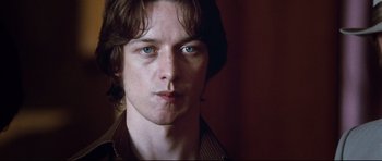 Movie still from “The Last King of Scotland” (2006), directed by Kevin Macdonald – A person wearing a brown shirt; Close Up shot, Low angle