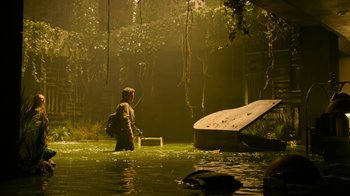Movie still from “The Last of Us” (2023), created by Neil Druckmann – A man standing in the middle of a river; Wide shot, Low angle