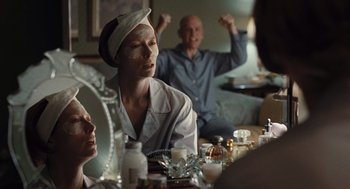 Movie still from “Burn After Reading” (2008), directed by Joel Coen – A group of people sitting around a table; Medium shot, Over the shoulder angle