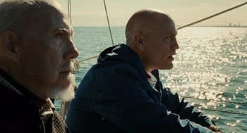 Movie still from “Burn After Reading” (2008), directed by Joel Coen – Two men sitting on a sailboat in the ocean; Close Up shot, Low angle