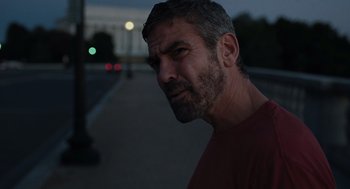 Movie still from “Burn After Reading” (2008), directed by Joel Coen – A person on a street at night; Close Up shot, Over the shoulder angle