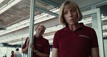 Movie still from “Burn After Reading” (2008), directed by Joel Coen – A man and a woman standing next to each other in front of a mirror; Close Up shot, Low angle