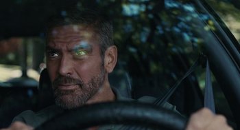 Movie still from “Burn After Reading” (2008), directed by Joel Coen – A person in a car looking at the camera; Close Up shot, Over the shoulder angle