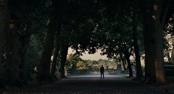 Movie still from “Burn After Reading” (2008), directed by Joel Coen – A man standing in the middle of a road; Extreme Wide shot, Over the shoulder angle