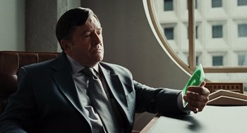 Movie still from “Burn After Reading” (2008), directed by Joel Coen – A man sitting at a table with his eyes closed; Close Up shot, Low angle