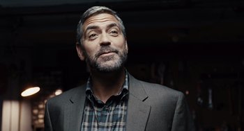 Movie still from “Burn After Reading” (2008), directed by Joel Coen – A person wearing a suit and tie; Close Up shot, Low angle