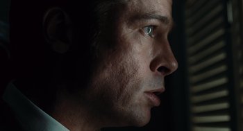 Movie still from “Burn After Reading” (2008), directed by Joel Coen – A person's face with a light on; Extreme Close Up shot, Low angle
